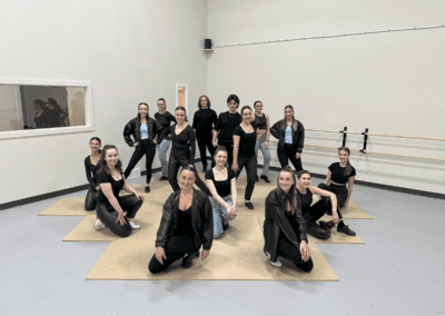 a group of people posing for a picture in black dress